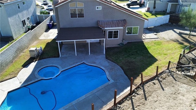 view of swimming pool with a jacuzzi, a yard, and a patio