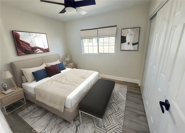 bedroom with a closet, ceiling fan, and light hardwood / wood-style floors