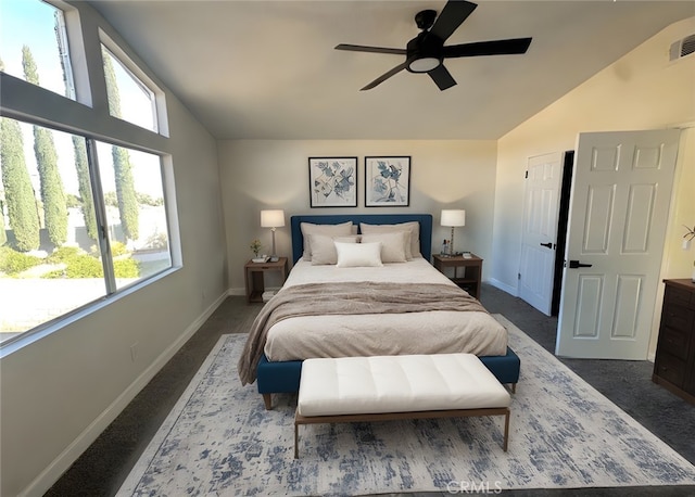 bedroom with ceiling fan, carpet floors, and lofted ceiling