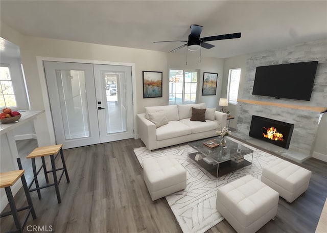 living room with a fireplace, french doors, ceiling fan, and hardwood / wood-style floors