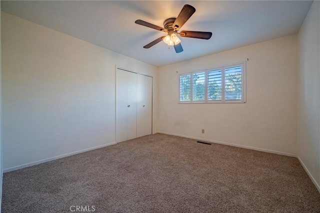 unfurnished bedroom featuring ceiling fan, carpet floors, and a closet