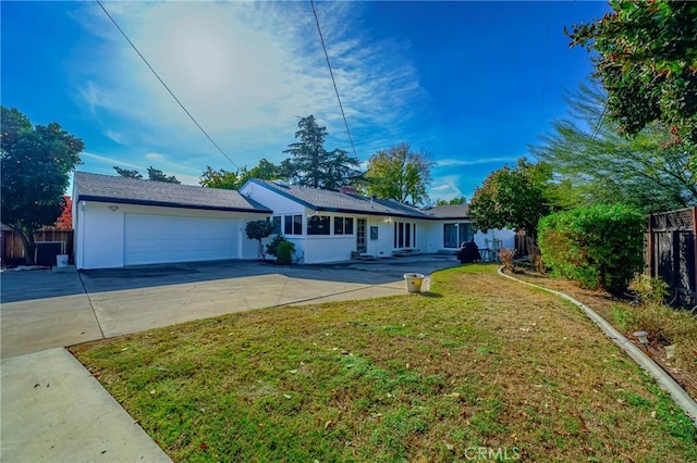 ranch-style house with a garage and a front lawn