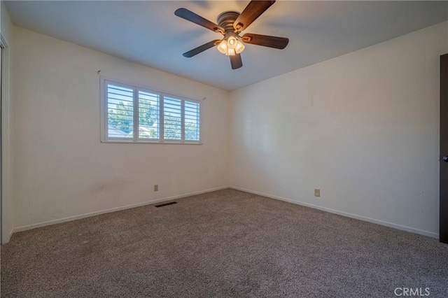 empty room with ceiling fan and carpet floors