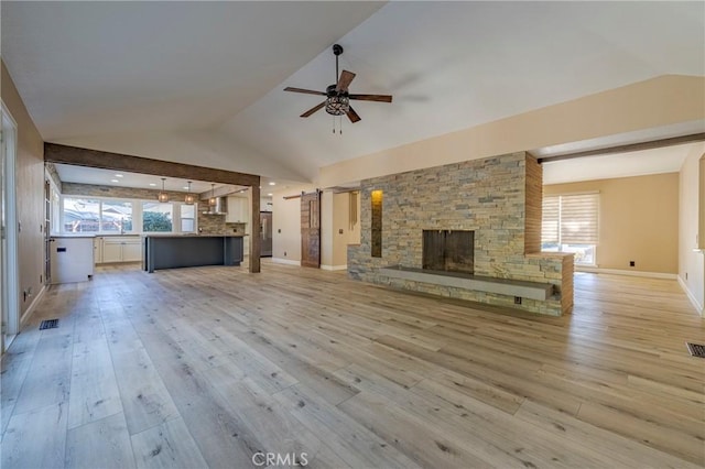 unfurnished living room with a fireplace, ceiling fan, light hardwood / wood-style flooring, and vaulted ceiling