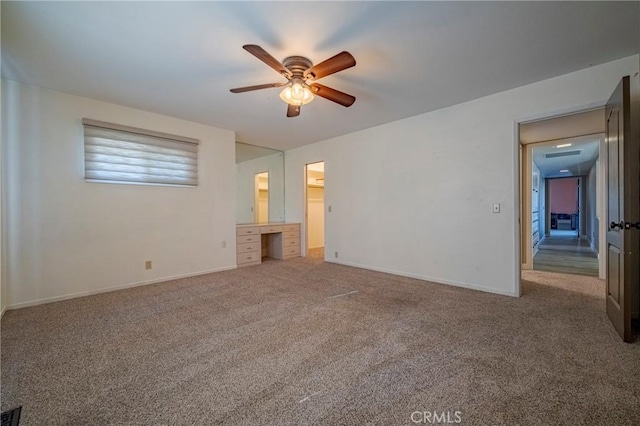 unfurnished bedroom featuring ceiling fan and carpet floors