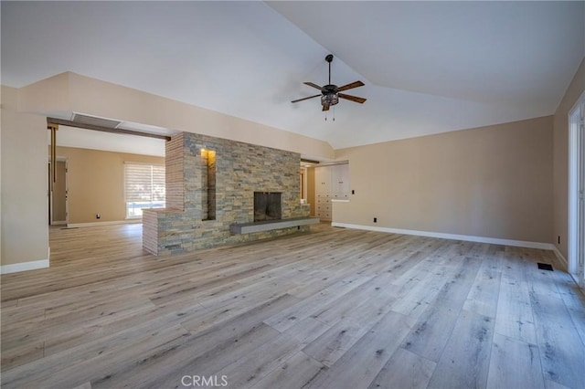 unfurnished living room featuring ceiling fan, lofted ceiling, a fireplace, and light hardwood / wood-style flooring