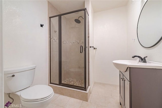 bathroom with tile patterned flooring, toilet, and a shower with shower door