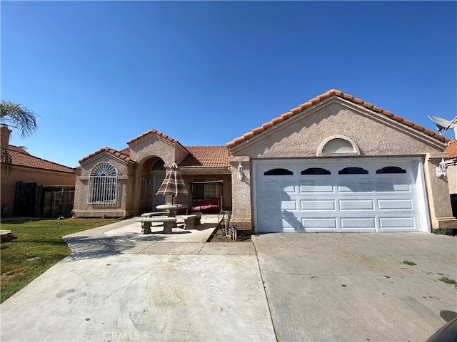 mediterranean / spanish-style home with a garage