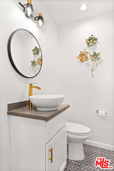 bathroom with toilet and vanity