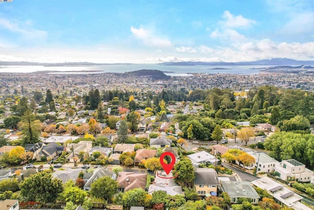 drone / aerial view featuring a water and mountain view