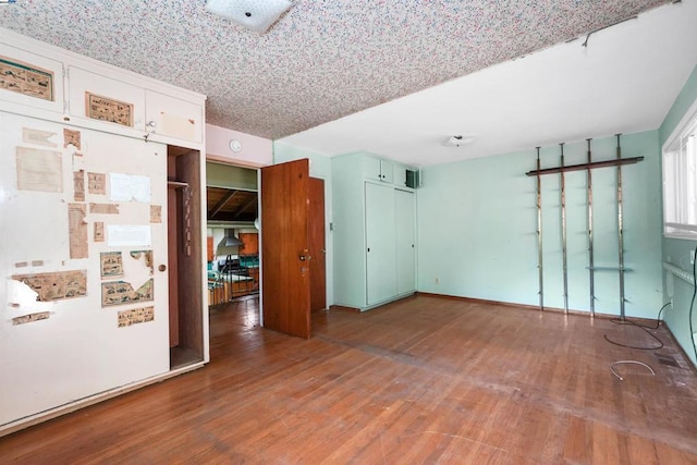 unfurnished room featuring hardwood / wood-style flooring