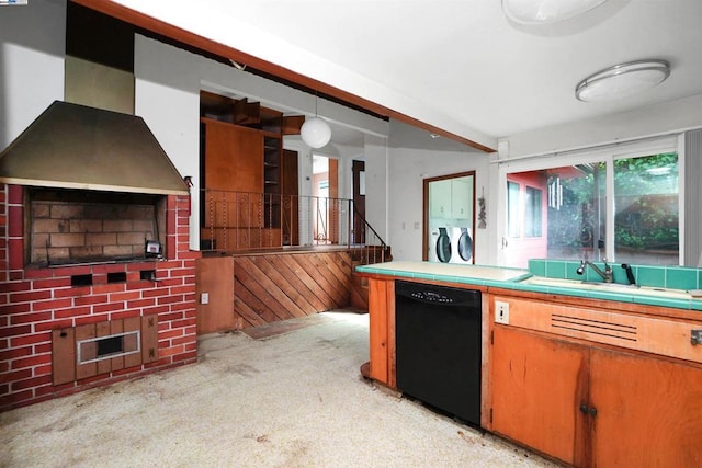 kitchen with washer and clothes dryer, pendant lighting, light carpet, sink, and black dishwasher