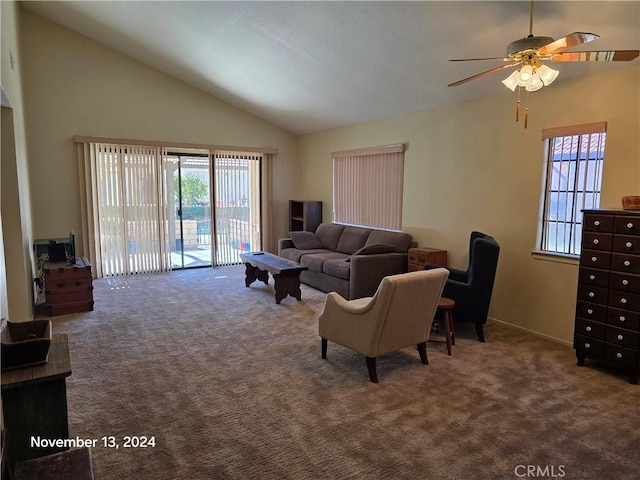 carpeted living room with ceiling fan and high vaulted ceiling