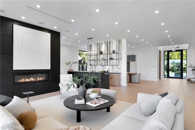 living room with a fireplace and light hardwood / wood-style flooring