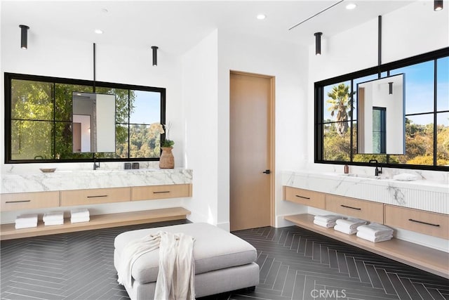 bathroom with vanity, parquet floors, and a wealth of natural light