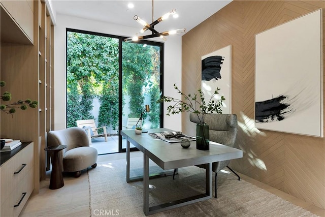 office area with a chandelier and wood walls