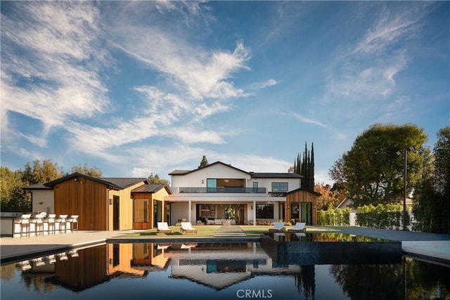 back of house with a patio area and a balcony