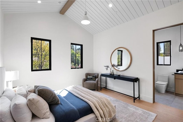 bedroom featuring lofted ceiling with beams, light hardwood / wood-style floors, and wooden ceiling