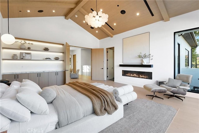 bedroom featuring a chandelier, beam ceiling, light wood-type flooring, and high vaulted ceiling