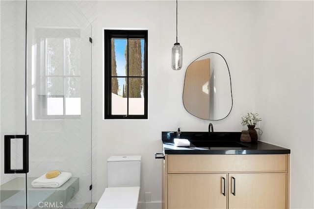 bathroom featuring vanity, toilet, and walk in shower