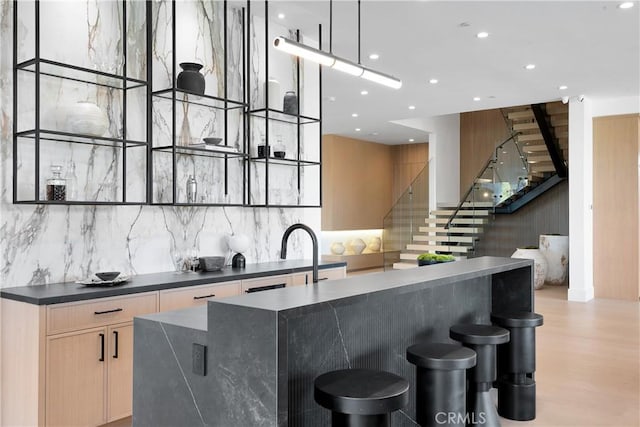 kitchen with decorative light fixtures, a center island, and tasteful backsplash