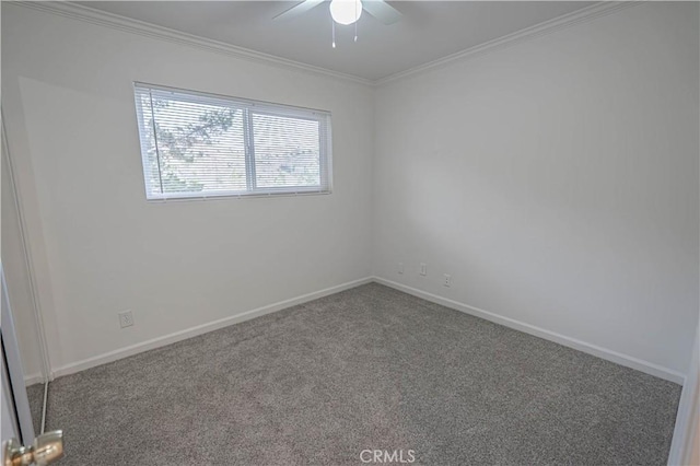 carpeted spare room featuring ceiling fan and crown molding