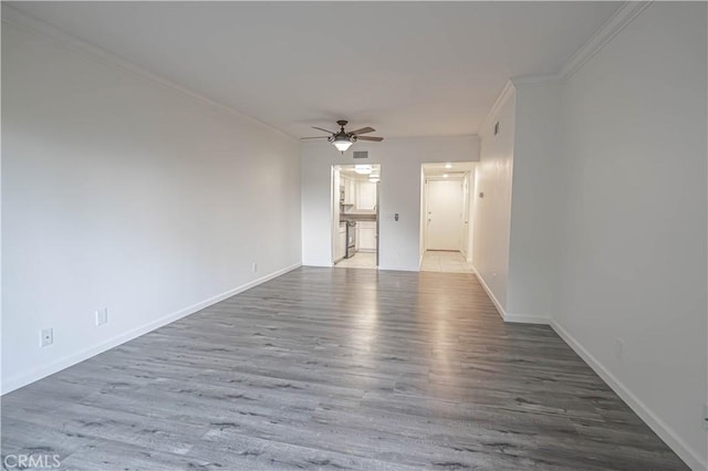 interior space with hardwood / wood-style floors, ceiling fan, and ornamental molding