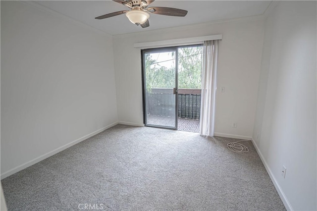 carpeted spare room featuring ceiling fan and crown molding