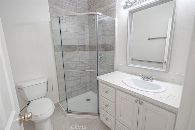 bathroom with tile patterned floors, vanity, toilet, and an enclosed shower