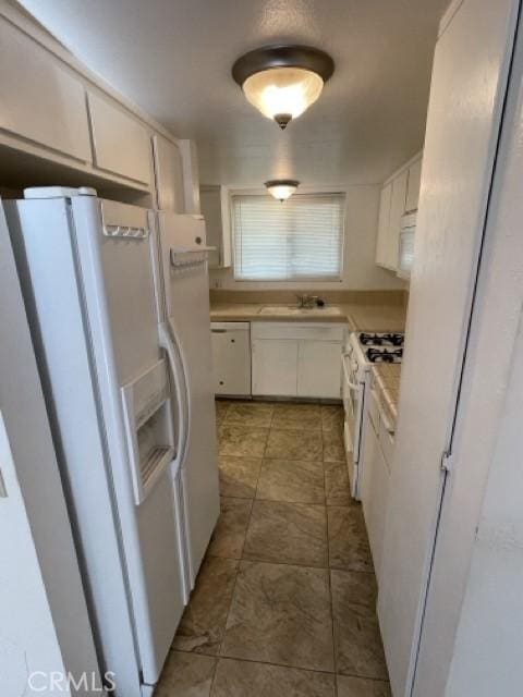 kitchen featuring white cabinetry, white appliances, and sink