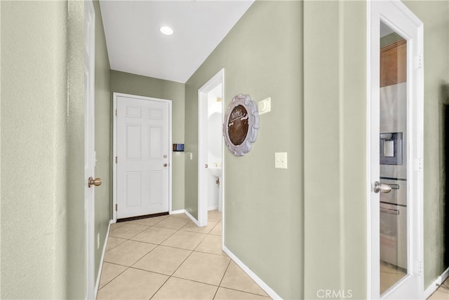 hallway featuring light tile patterned floors