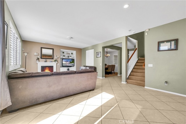 unfurnished living room with light tile patterned flooring and a chandelier