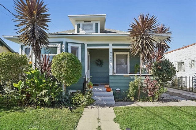 bungalow-style home with a front lawn