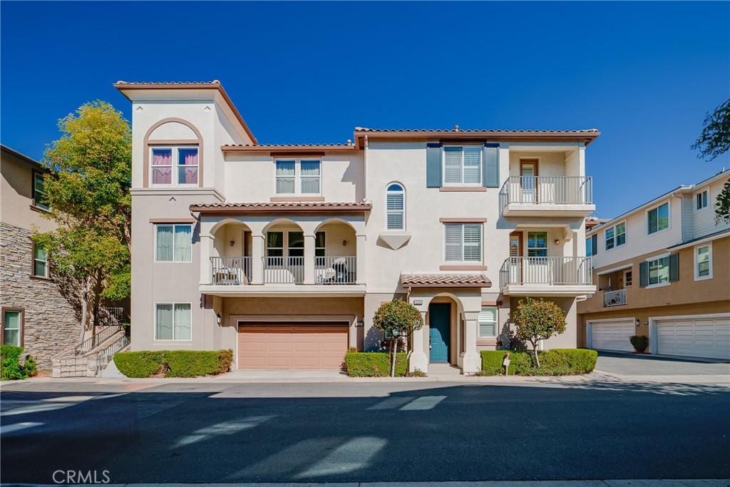 mediterranean / spanish home with a garage