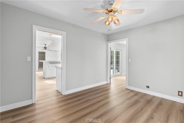 spare room featuring ceiling fan and light hardwood / wood-style flooring