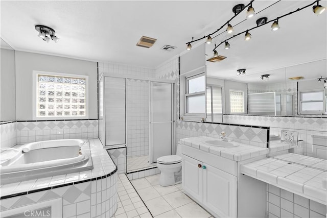 full bathroom with tile patterned flooring, vanity, toilet, and tile walls