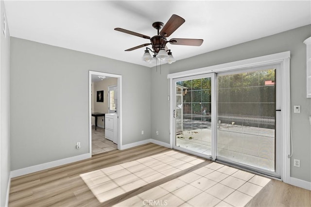 spare room featuring light wood-type flooring and ceiling fan