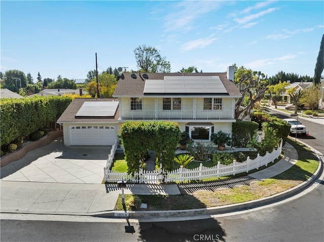 view of front of house featuring solar panels and a garage