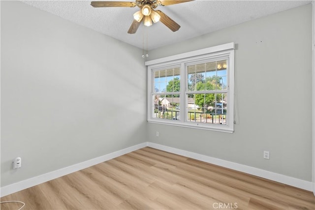 unfurnished room featuring ceiling fan, light hardwood / wood-style flooring, and a textured ceiling