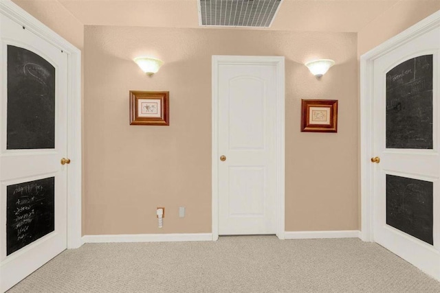 unfurnished living room with light colored carpet