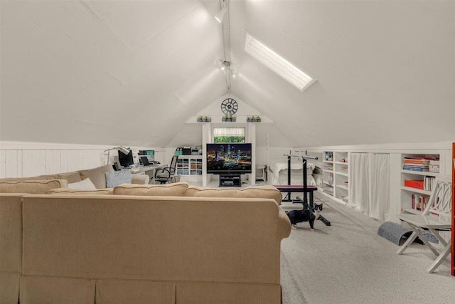 carpeted living room with vaulted ceiling with skylight