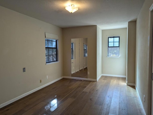 spare room with wood-type flooring