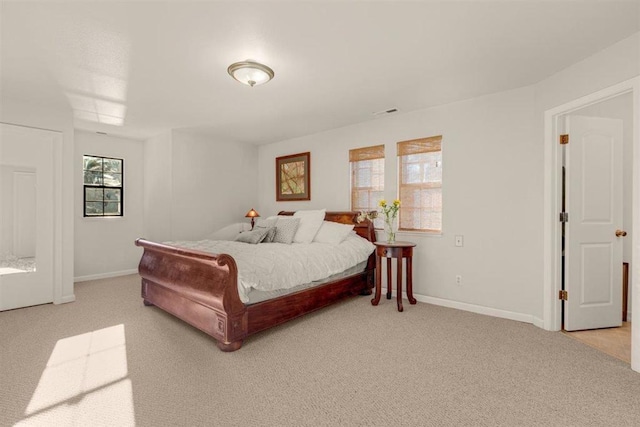 bedroom featuring light carpet