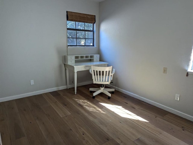 unfurnished office with dark wood-type flooring