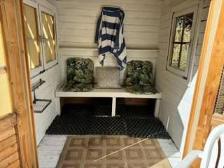 mudroom featuring wood walls