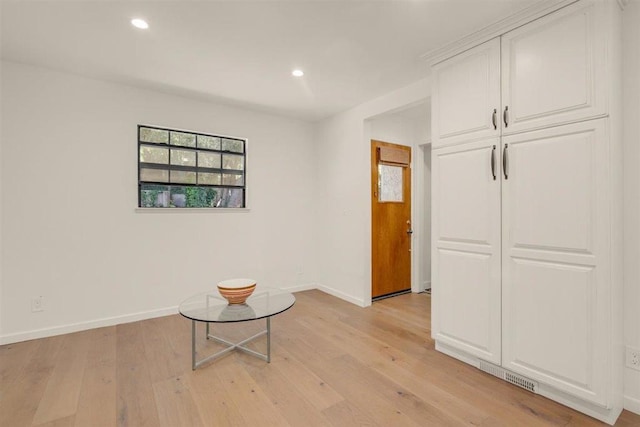 corridor with light hardwood / wood-style flooring