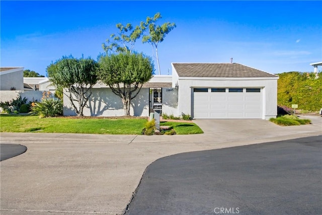 view of front of home featuring a garage and a front lawn