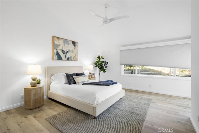 bedroom with ceiling fan and light wood-type flooring