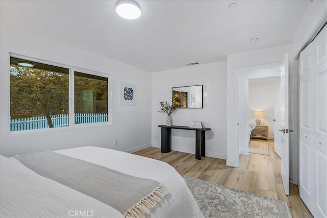 bedroom with a closet and light hardwood / wood-style flooring