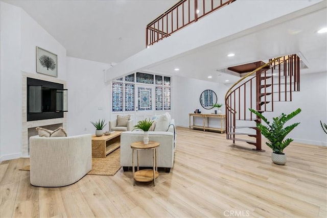 living room featuring light wood-type flooring and vaulted ceiling